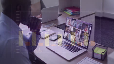 in office, businessman in virtual meeting, viewing data analytics on laptop screen