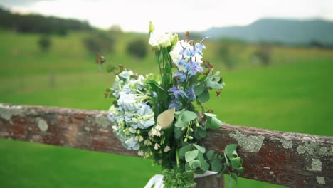 decorative flower arrangement on meadow blurry background during outdoor wedding ceremony