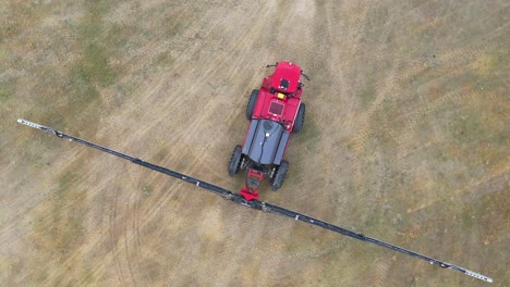 red sprayer tractor on farm land ready to spray