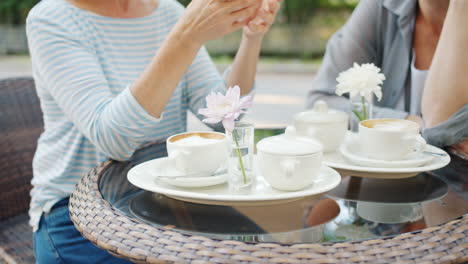 women friends enjoying coffee outdoors