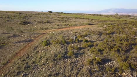 hombre huyendo de algo seguido por un dron en el campo