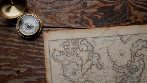 antique map and compass on wooden tabletop