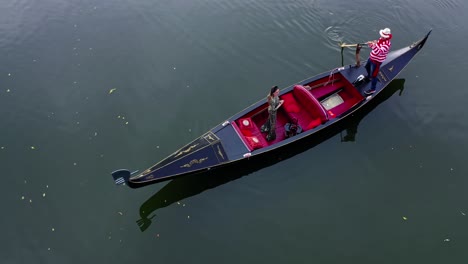 luxury woman travels in gondola. italian gondola floating on the blue river background. woman standing in a boat. top view.