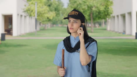 Indian-female-security-guard-talking-to-someone-on-call