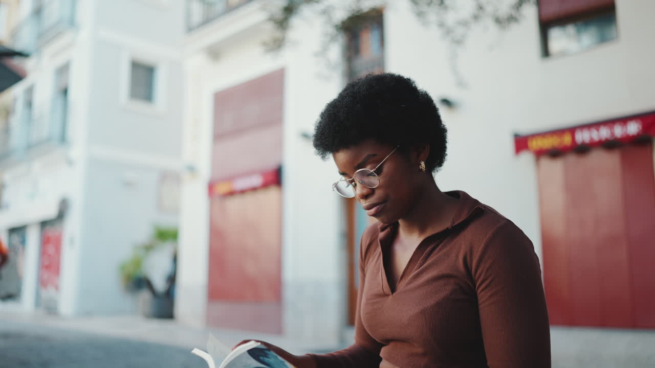 Female dark-skinned student studying outdoors