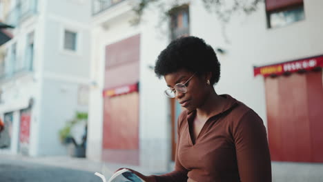 Female-dark-skinned-student-studying-outdoors