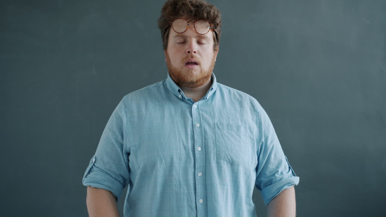 Man with Glasses and Meditative Pose