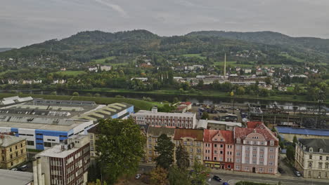 decin czechia aerial v7 low level drone flyover riverside industrial area along the elbe river channel capturing hillside cityscape views - shot with mavic 3 cine - november 2022