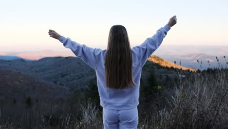 a woman atop a mountain embraces freedom symbolizing strength this inspiring video shows a woman on a mountain arms outstretched embracing the vast landscape it symbolizes strength adventure and natures beauty