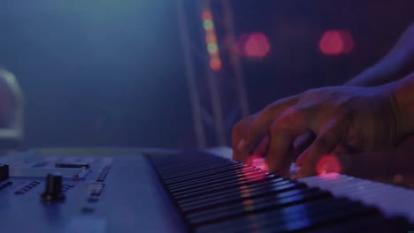 animation on blurred night road traffic over hands of caucasian man playing keyboard on concert