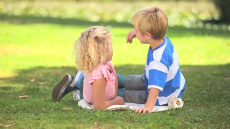 young boy and his sister talking