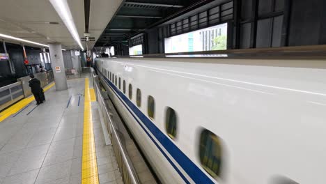 a train speeds through a modern train station