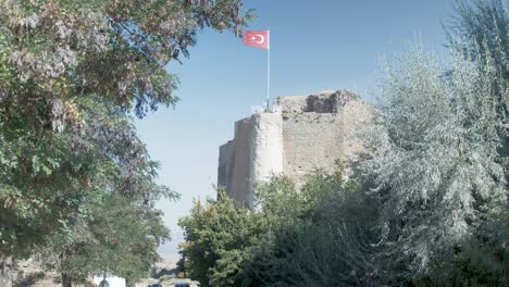 turkish flag atop harput castle telephoto mid shot