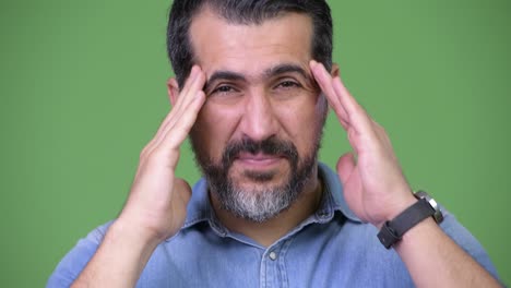 handsome persian bearded man having headache