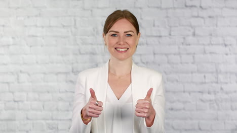 a young business woman gives her approval with a thumbs up gesturing a yes