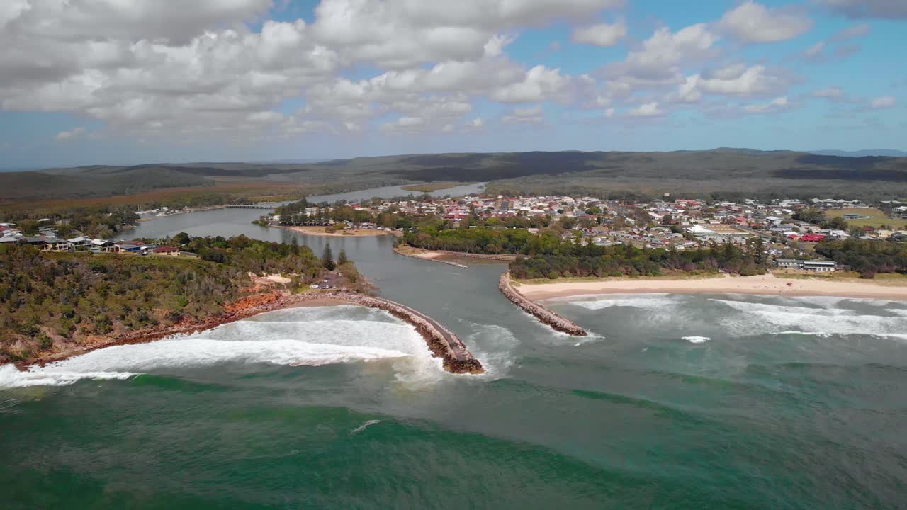 vista aérea de drones hacia las olas que golpean la costa del pueblo de evans head, en australia