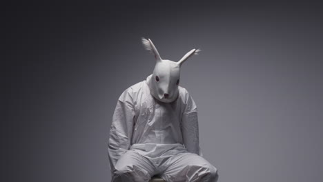 person in rabbit mask and white hazmat suit