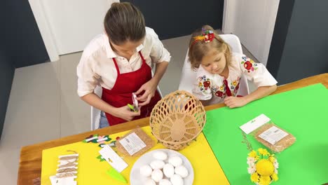 mother and daughter making easter decorations