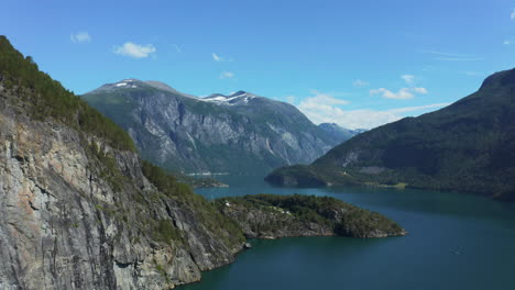 Aerial-view-over-the-Storfjorden,-in-middle-of-high-mountains,-summer-in-Norway---circling,-drone-shot