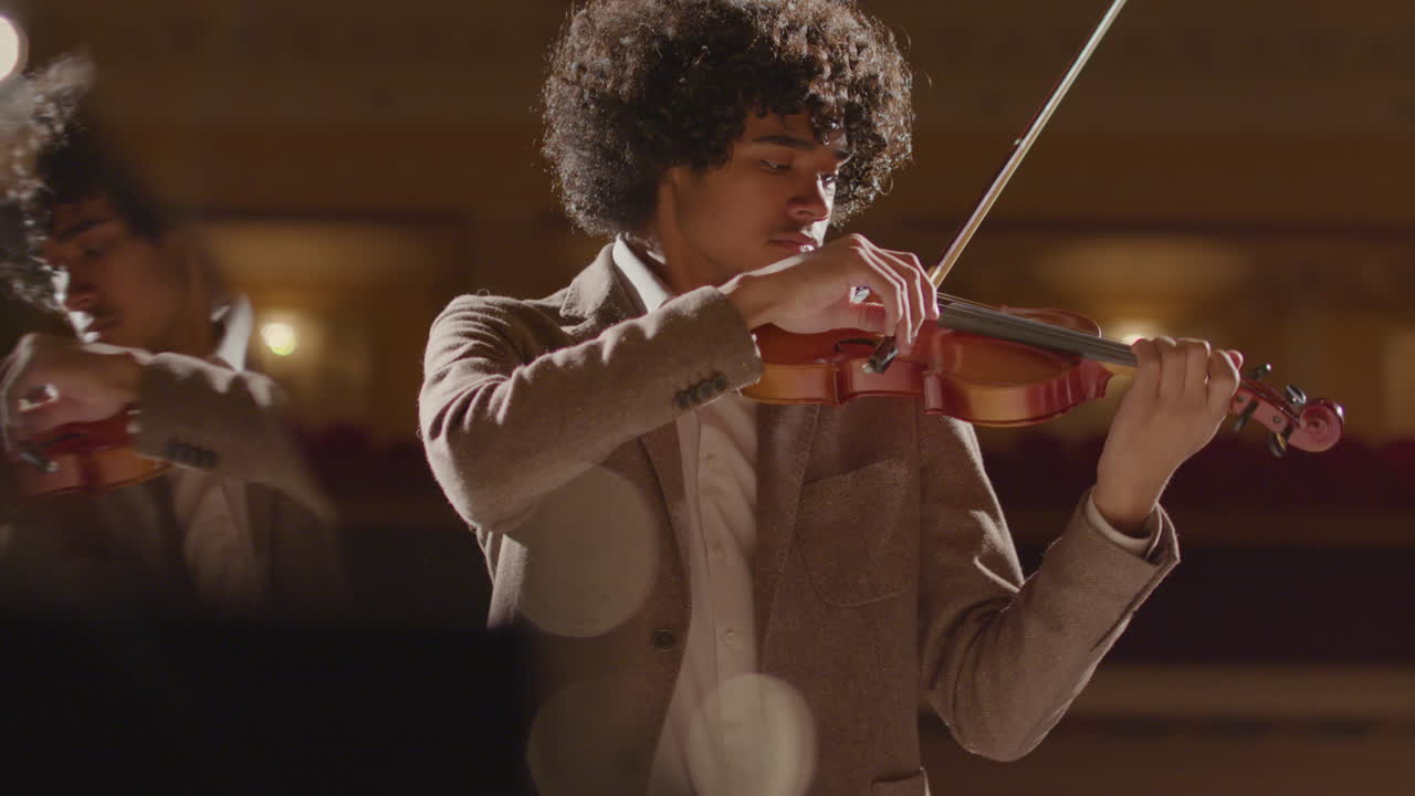 Young Black Man Playing Violin with Piano Accompaniment