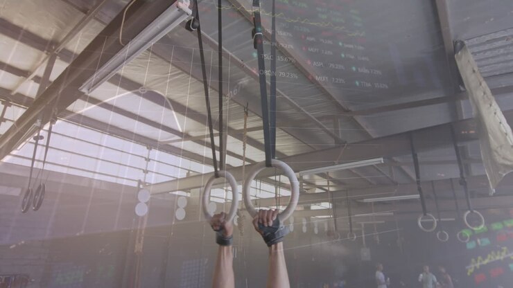 Animation of interface processing data over biracial man training on gym rings at gym