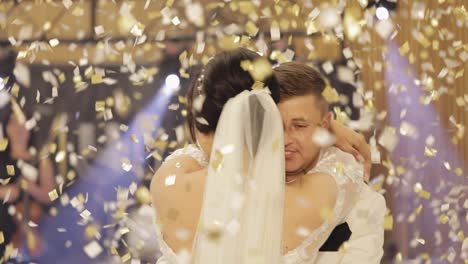 Caucasian-bride,-groom-dancing-first-at-the-wedding-party,-newlyweds-embracing,-falling-confetti