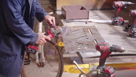 worker grinding steel metal sheet in industrial workshop, 4k slow motion