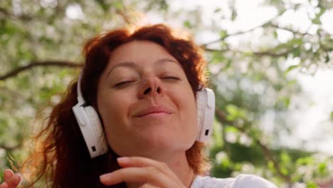 woman listening to music in a blooming spring park