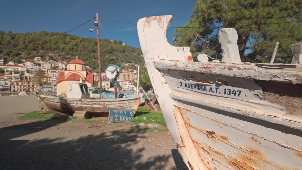 Old neglected Greek Fishing boats abandoned on coastal boat yard