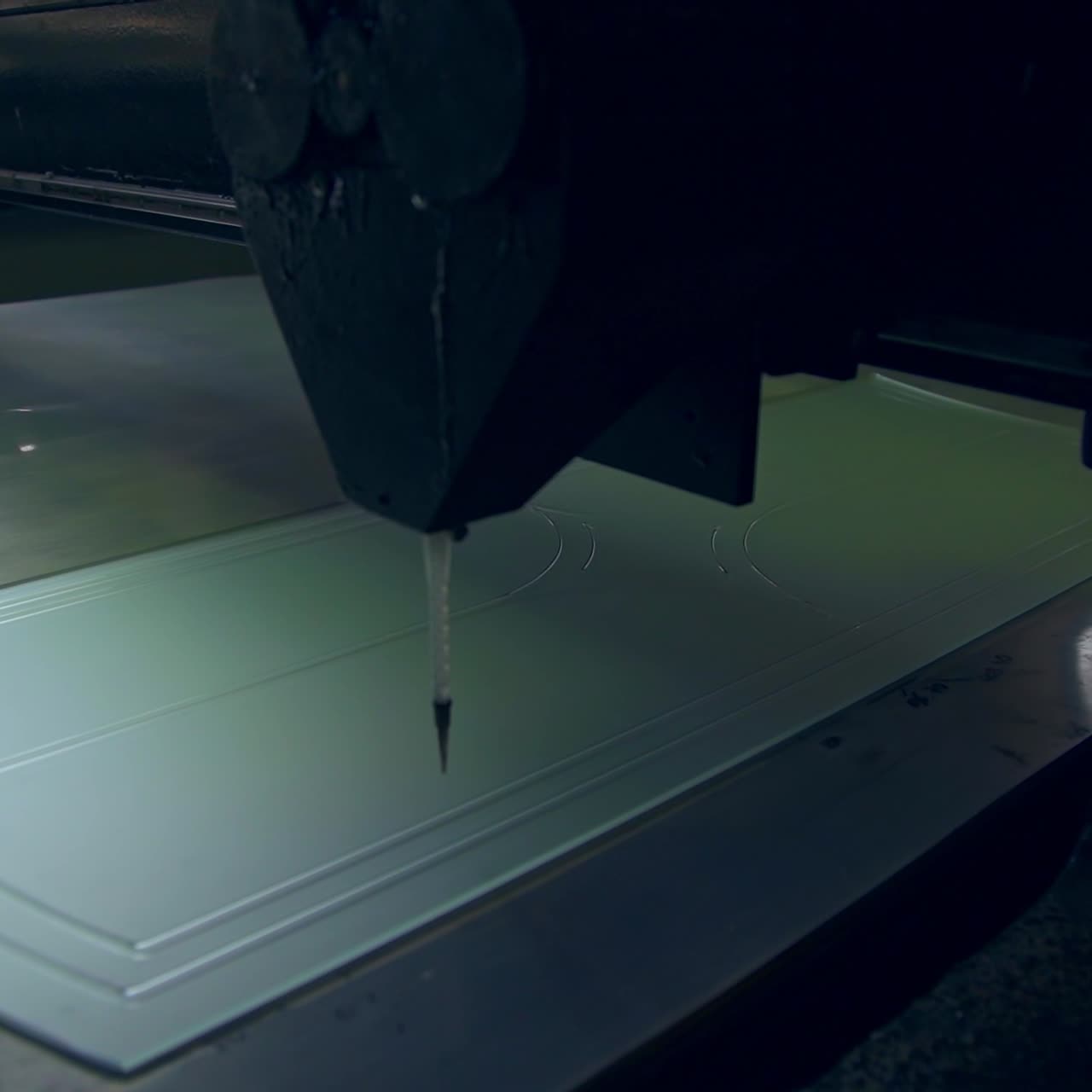 Piece of frosted glass is decorated with lines. Picture is applied on the future door by the automated tool machine