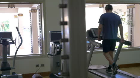 working out on treadmill in modern gym