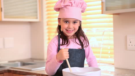 smiling little girl cooking