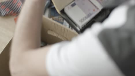 person packing tools in box