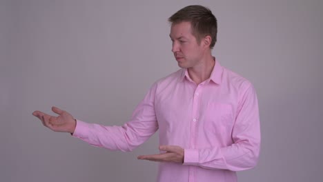 young handsome businessman with pink shirt