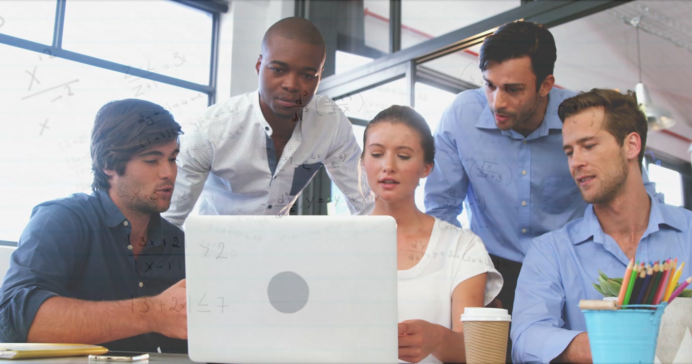 Left man pointing at laptop, team leaning in, woman operating laptop reviewing business plan