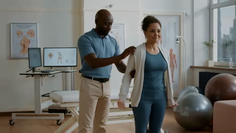 physical therapist examining patient's posture