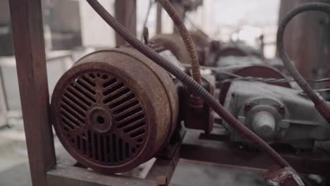 row of rusty pressure washers at an old abandoned car wash