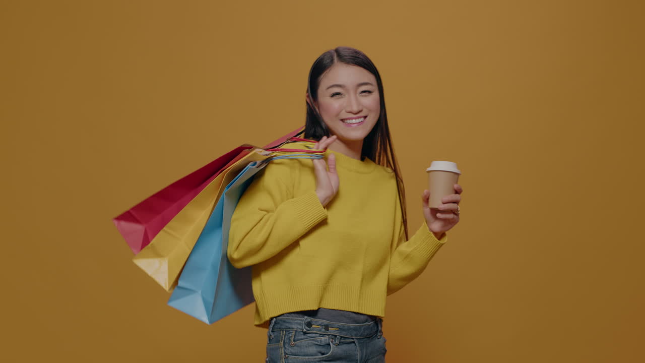 Cheerful adult holding shopping bags after buying clothes