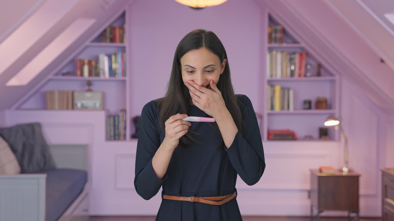 Happy Indian girl checking pregnancy test