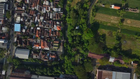 4k drone footage showcasing a serene village with a large, meandering river cutting through the landscape. perfect for travel, nature, and scenic projects