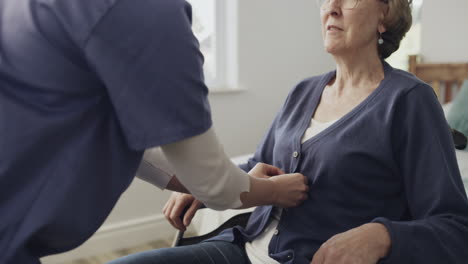 nurse assisting senior woman