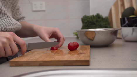 female hands cutting tomatoes on the cutting board hands chopping tomatoes in the kitchen salad preparation