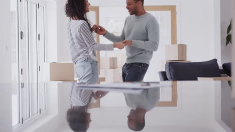 loving couple dancing together as they celebrate moving into new home