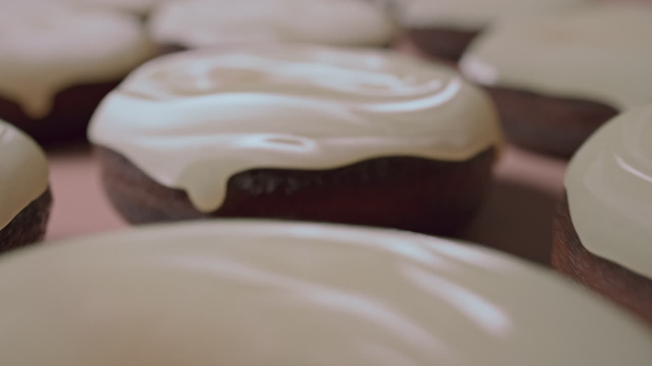 White glaze donuts on a light pink background