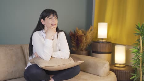 woman biting her nails because of stress at home at night.