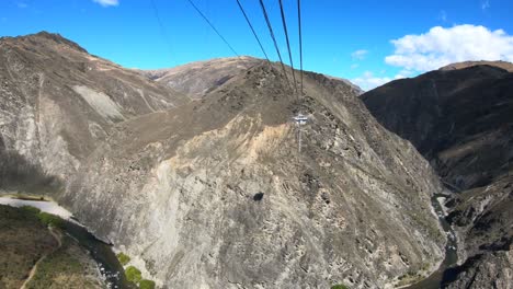 riding the cart out to the jumping platform to bungy jump at the nevis bungee jumping site in queenstown new zealand