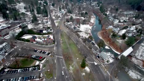 aerial flying over the green beside the ottauquechee river through woodstock in vermont