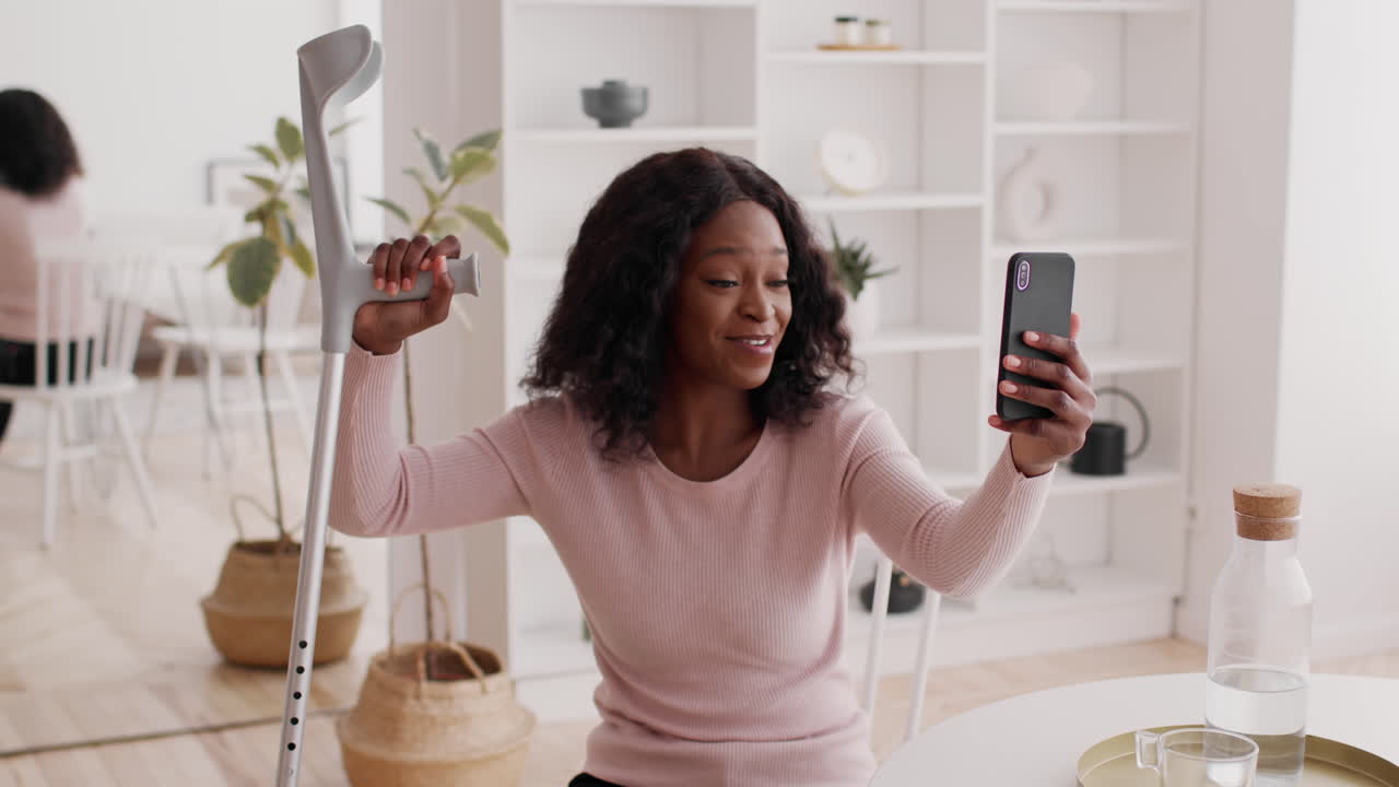 Woman on video call with crutch