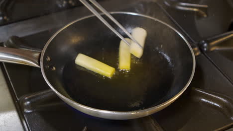 grilled leeks with sauce and sprouts