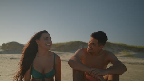 Young-couple-sunbathing-at-the-beach